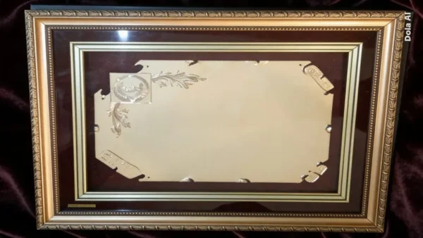 Plaqueta conmemorativa tipo cuadro con acabado en oro, marco decorativo y estuche de lujo de Nevey Medallas. Modelo 6100
